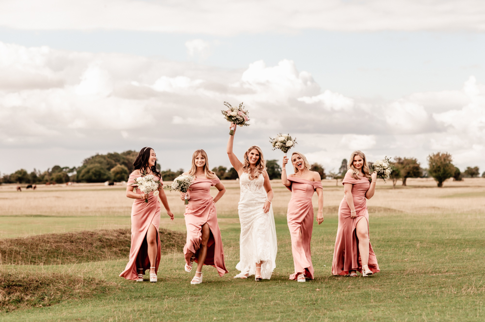 bride and bridesmaids walking countryside minchinhampton common