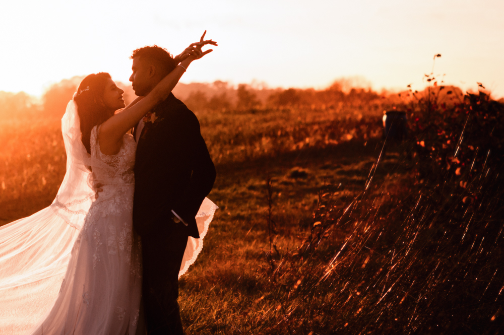 bride and groom hugging sunset