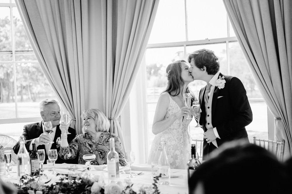bride and groom kissing  eastington park cotswolds