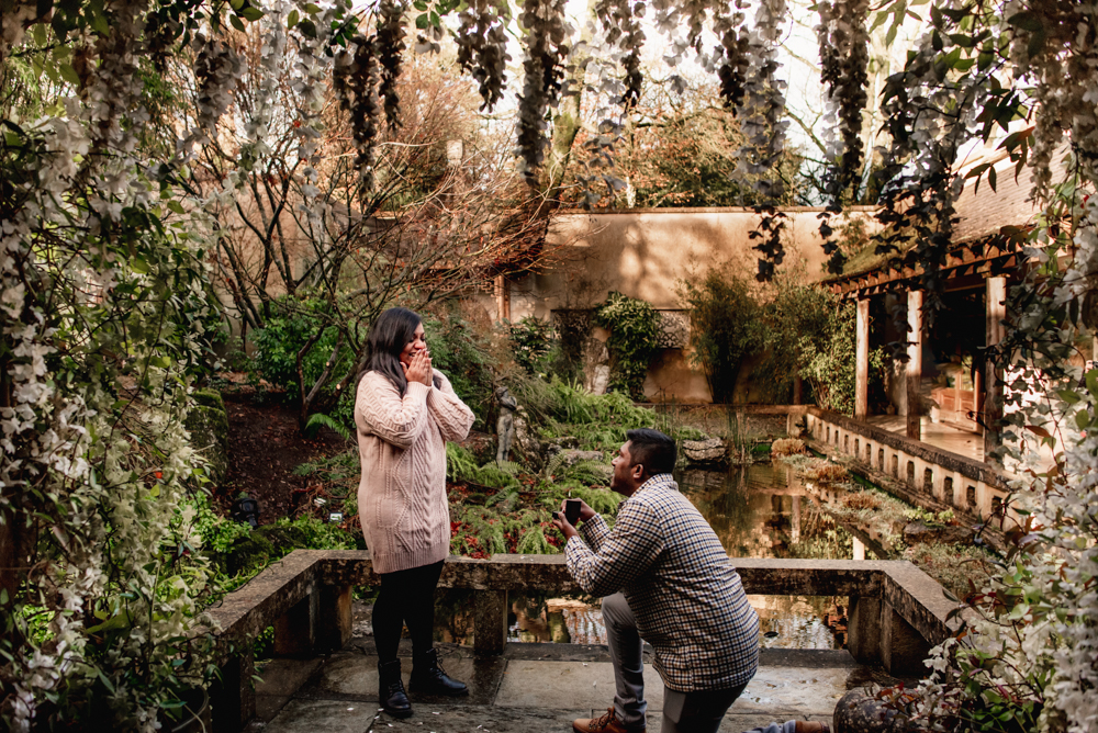 man proposing to woman by a pond