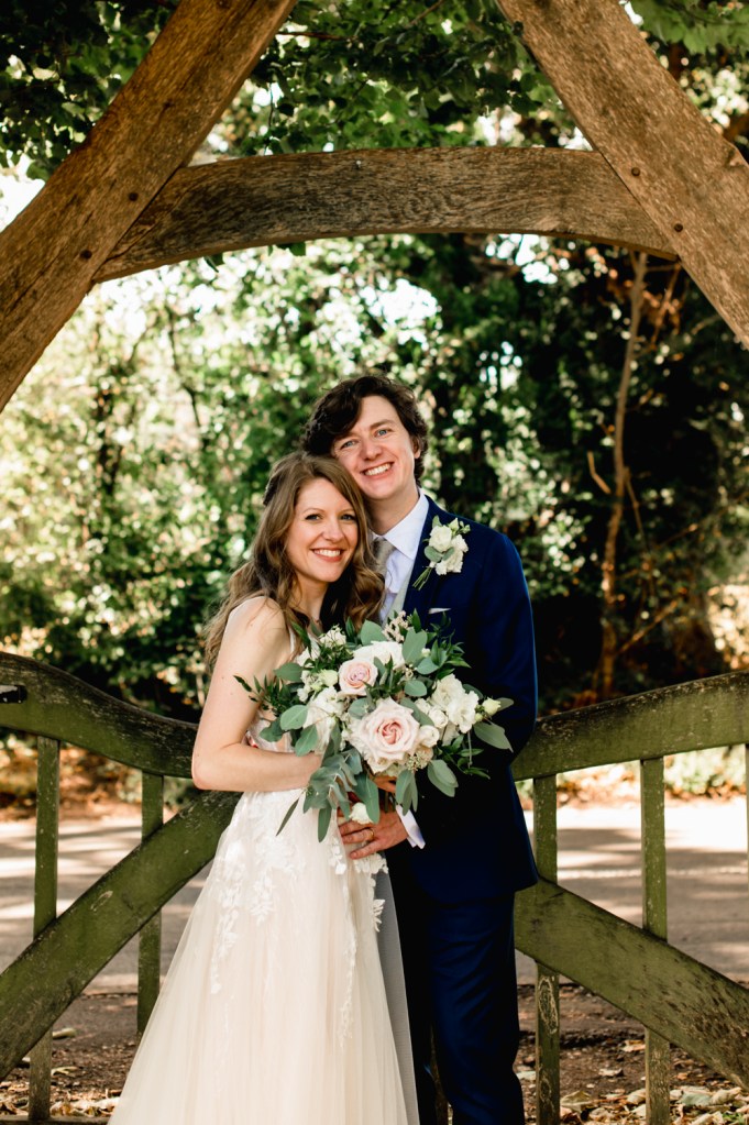 bride and groom under arch romantic wedding photo cotswolds