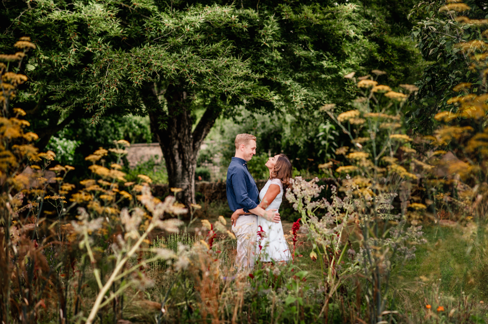 couple hugging countryside cotswolds