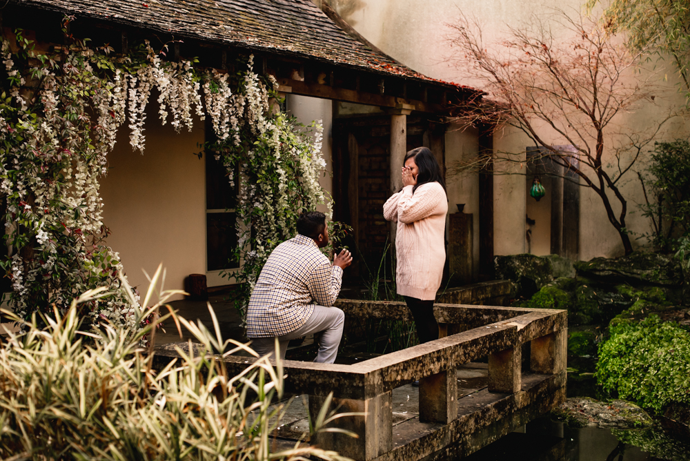 man proposing to woman on a bridge