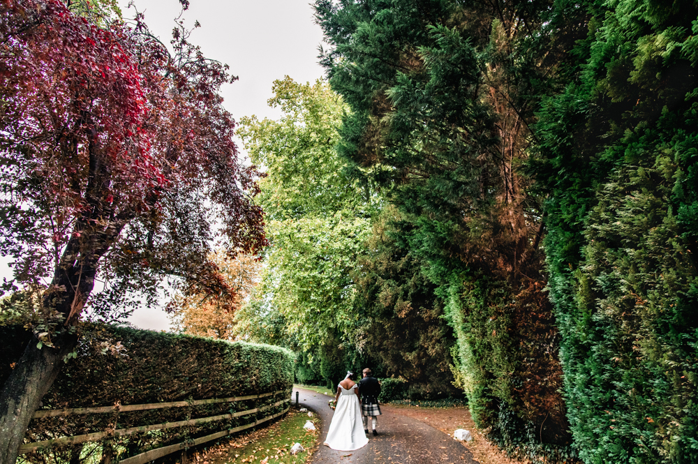 autumn drive greenway hotel bride and groom walking
