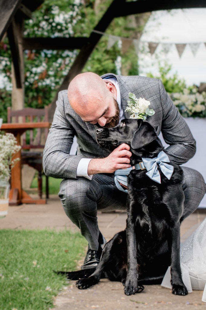 groom and dog old lodge wedding