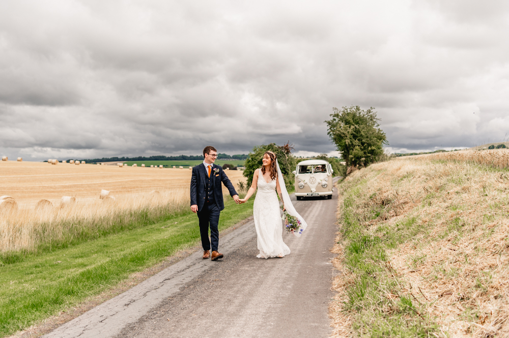 bride and groom running camper van