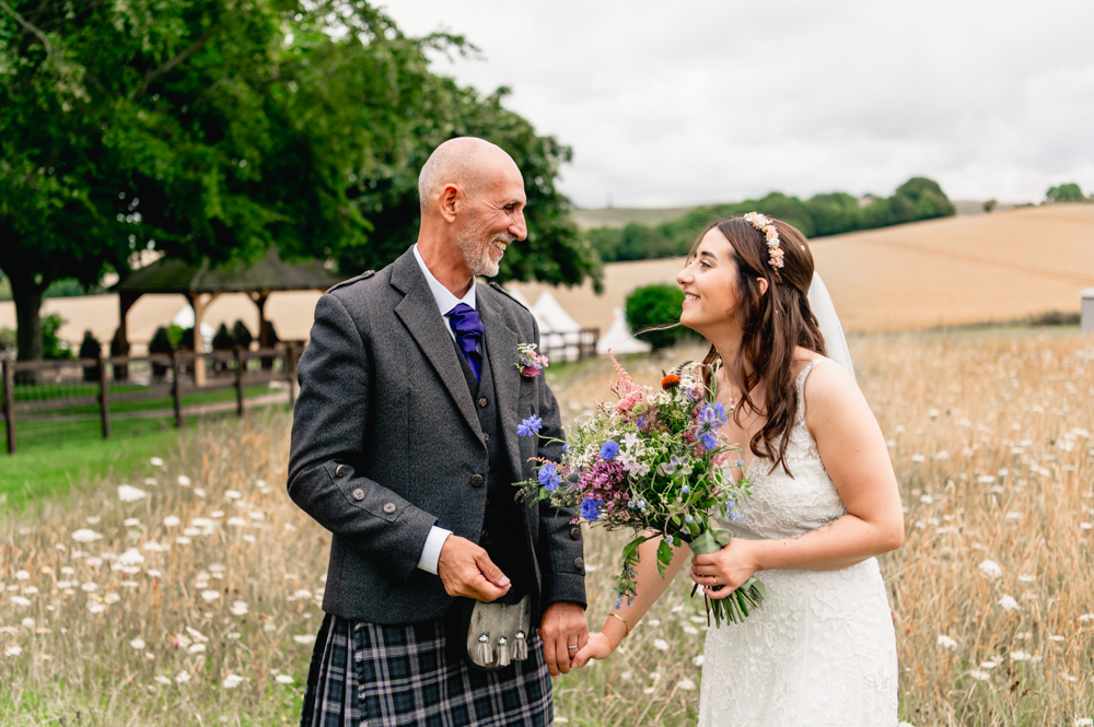 bride and dad in meadow