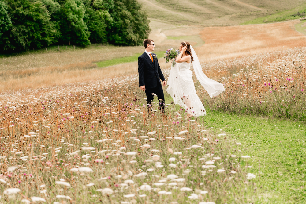 bride and groom in meadow