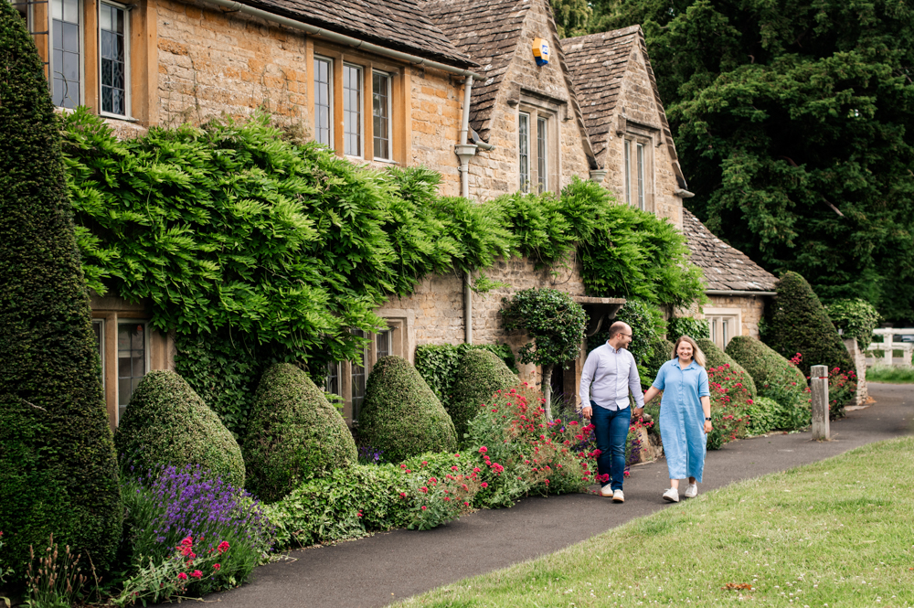 couple walking pretty village engagement photography