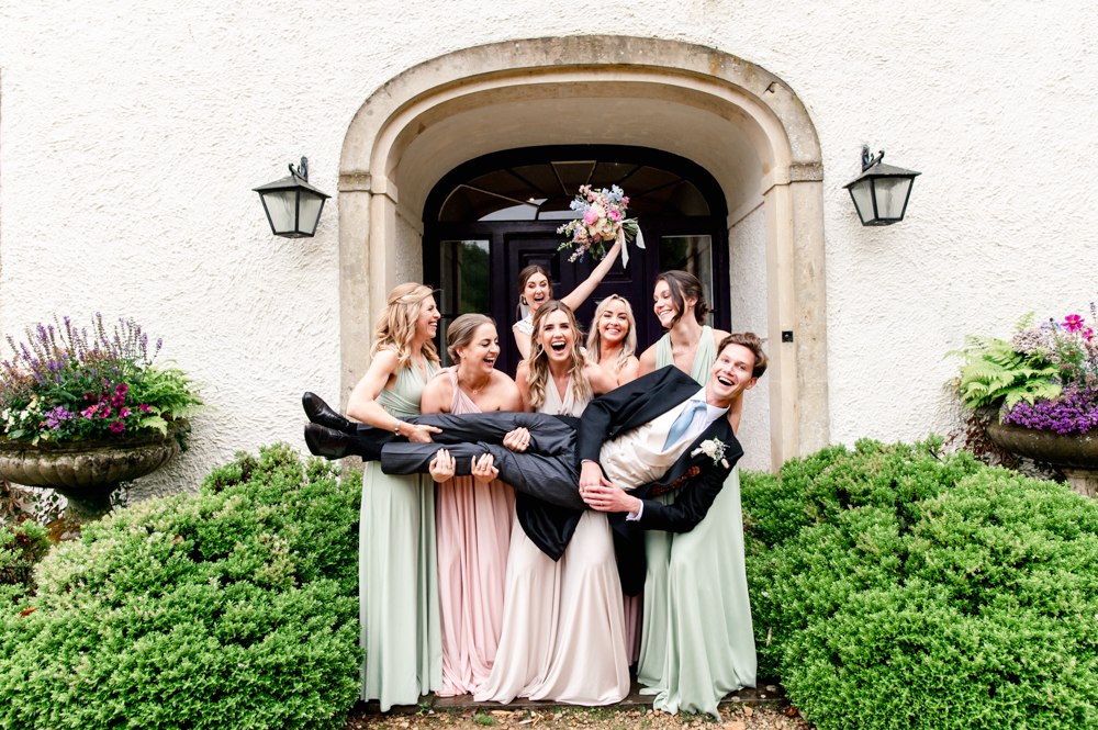 bridesmaids lifting groom