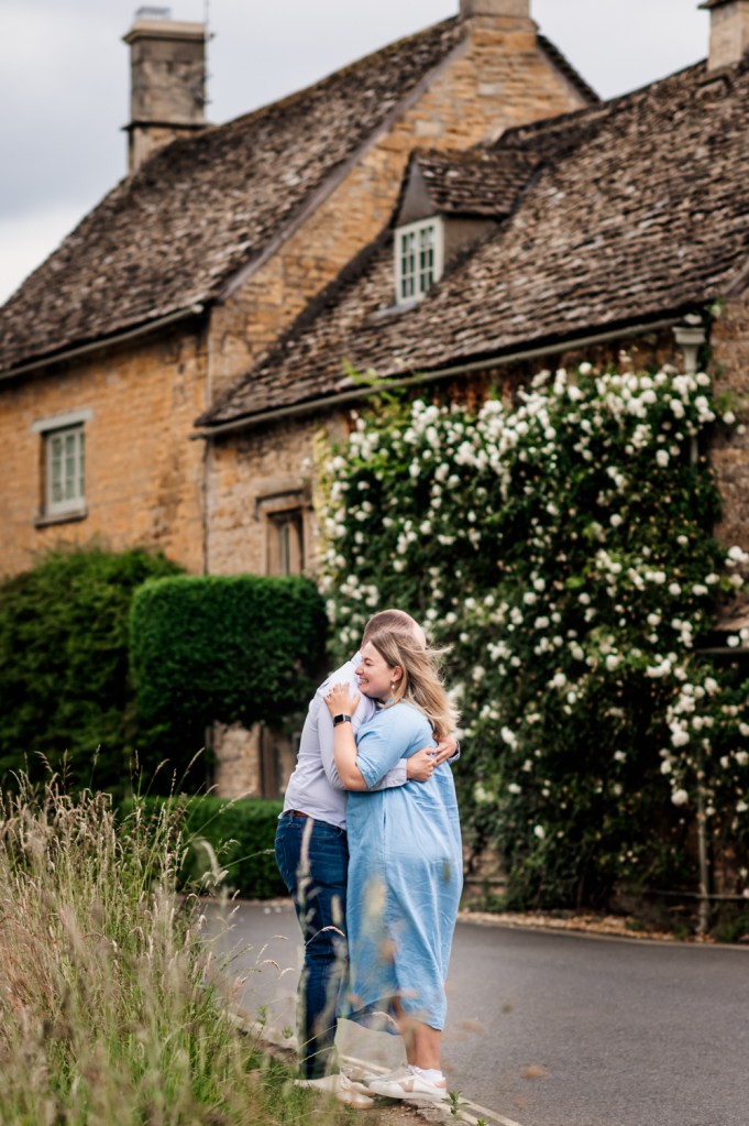 couple hugging by  cotswolds house   engagement photography