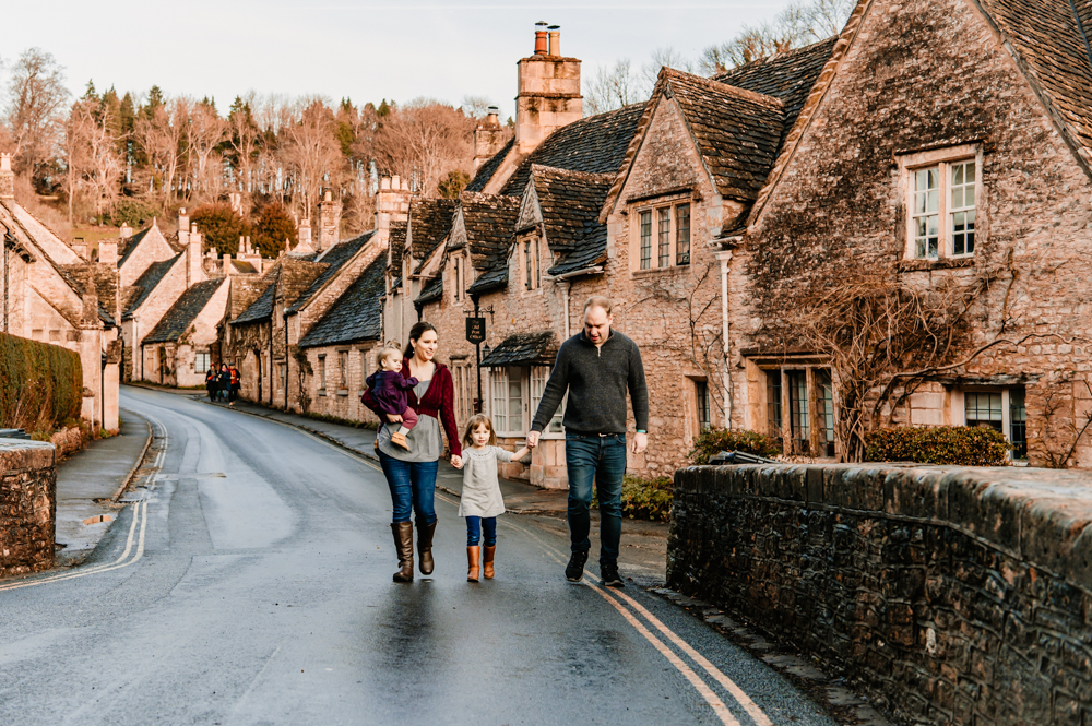 family walking cotswold village