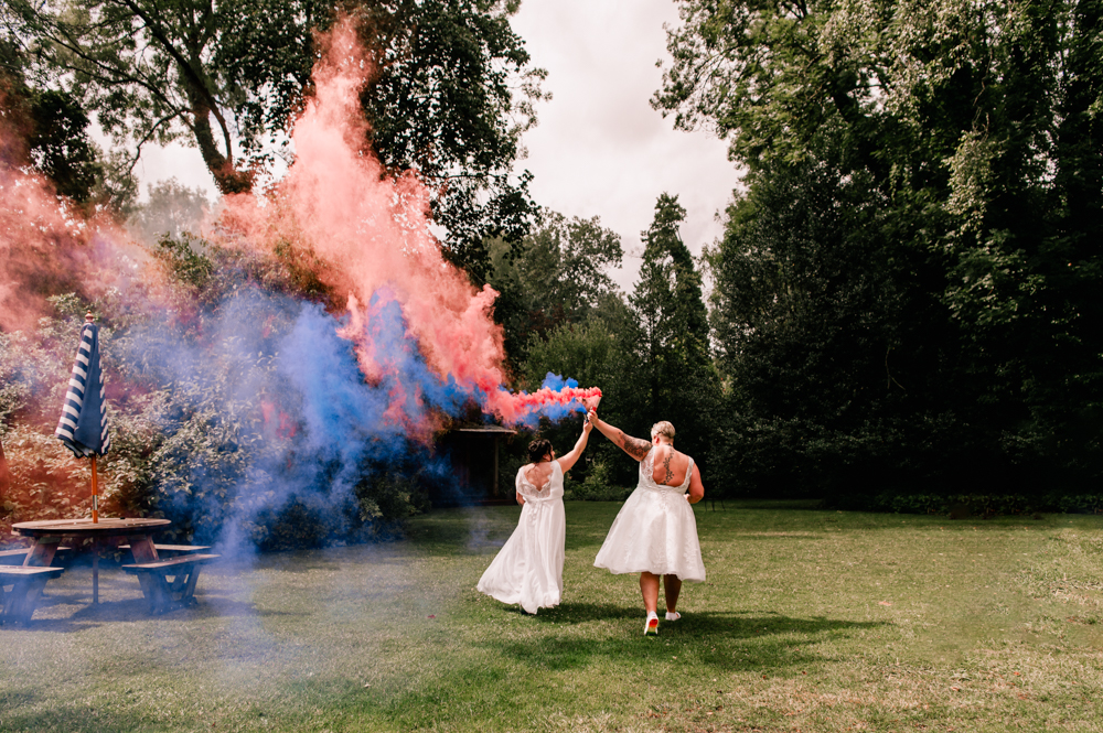 two brides running pink smoke