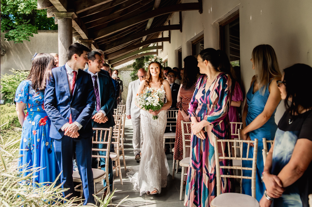 bride walking down aisle outdoor wedding