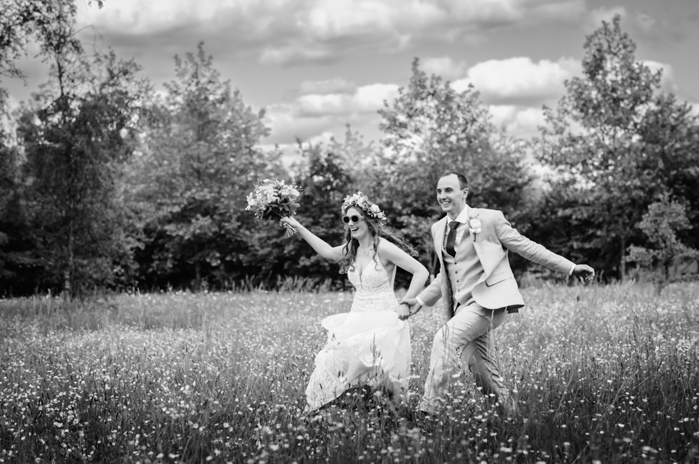 fun relaxed couple running meadow