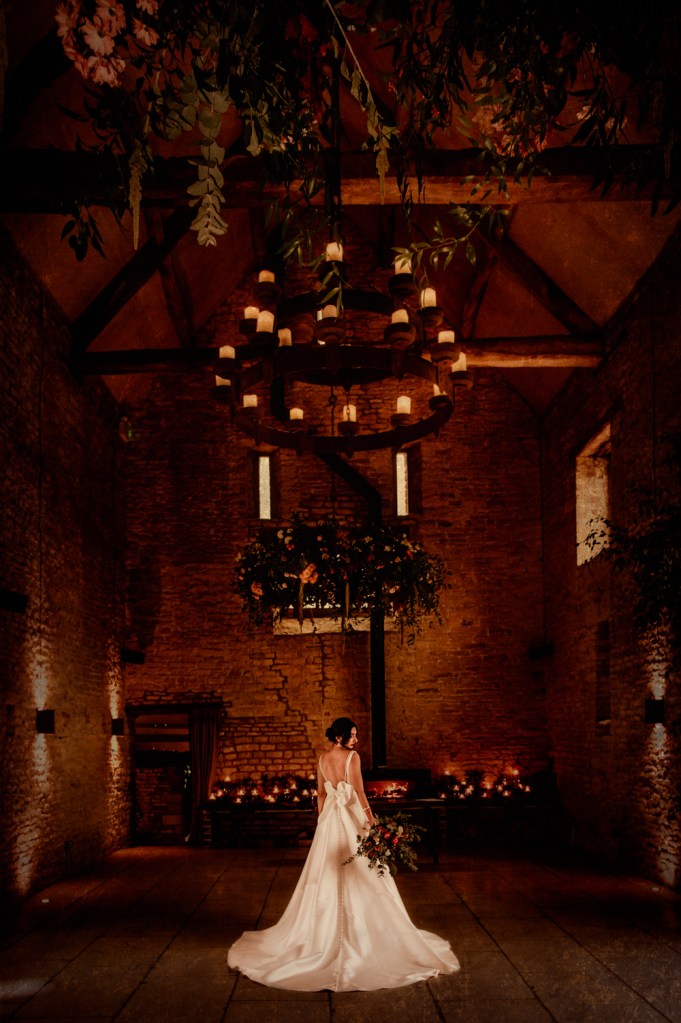 bride in a barn woih a bow