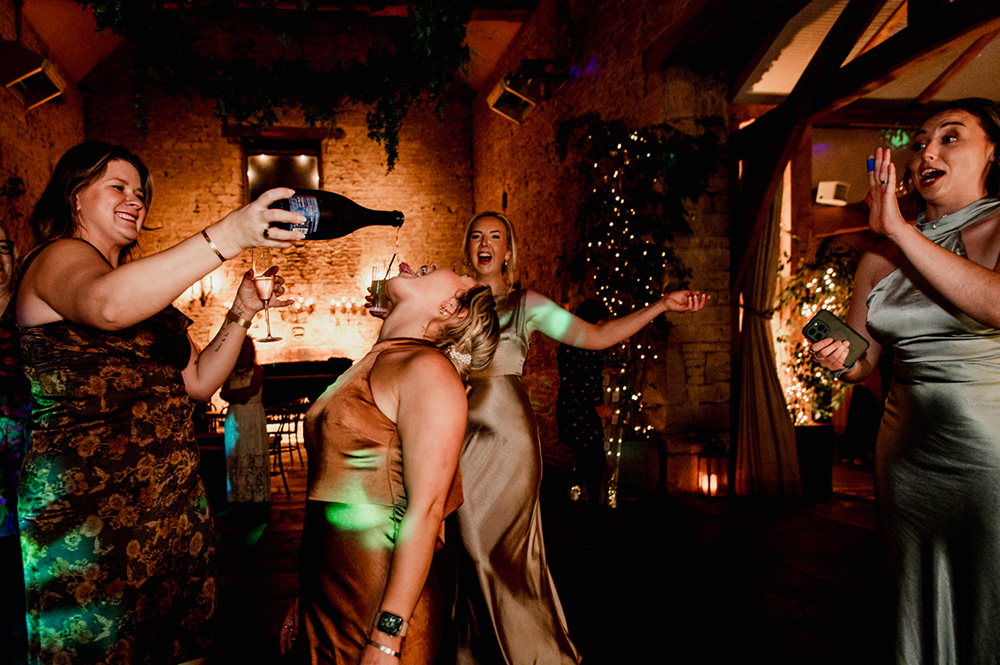 bridesmaids pouring champagne