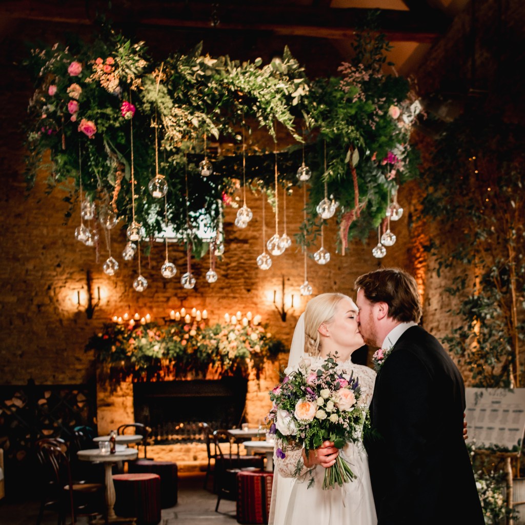 flower wheel barn bride groom kissing