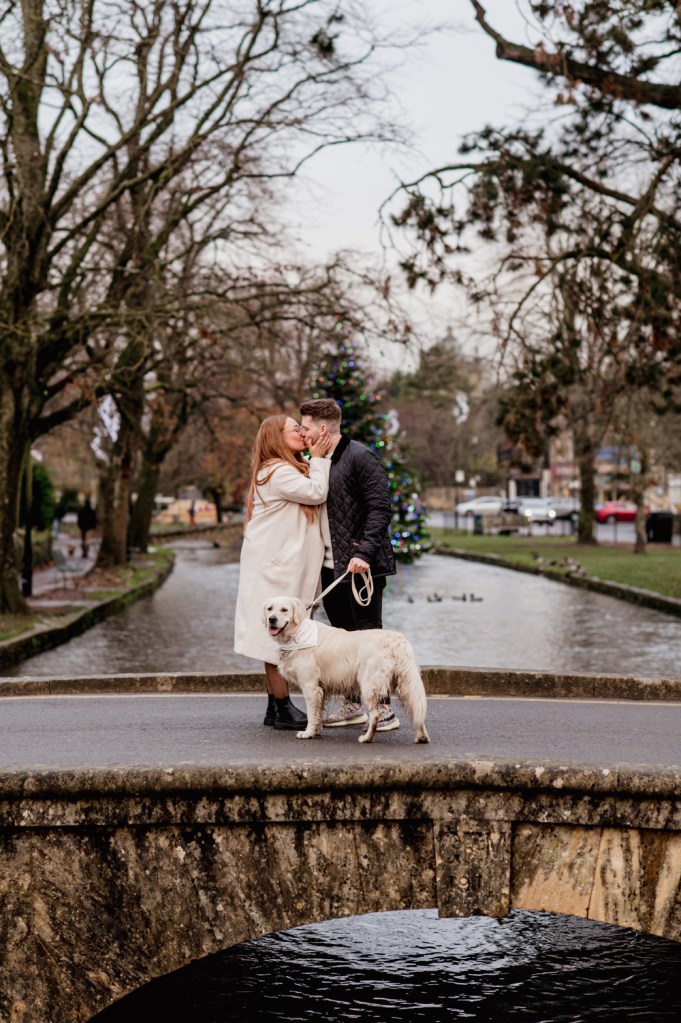 couple on bridge kissing