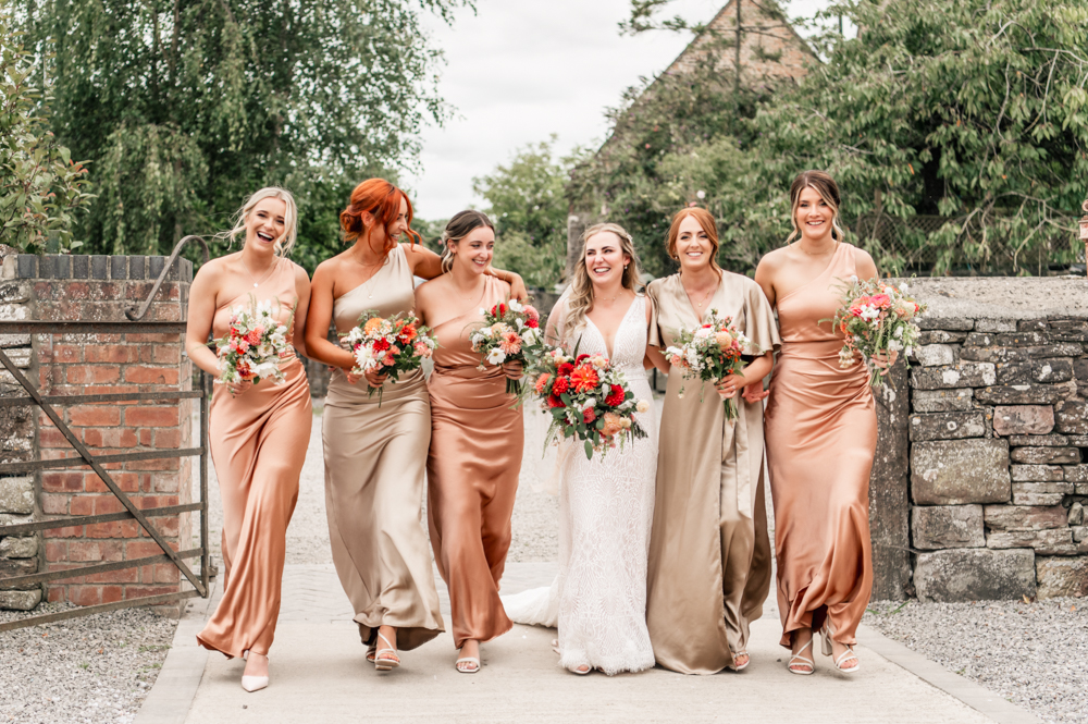 bride and bridesmaids walking farm