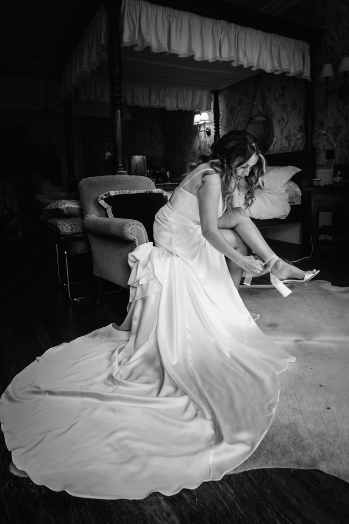 bride putting shoes on