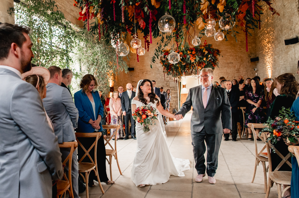 bride going down aisle old gore barn