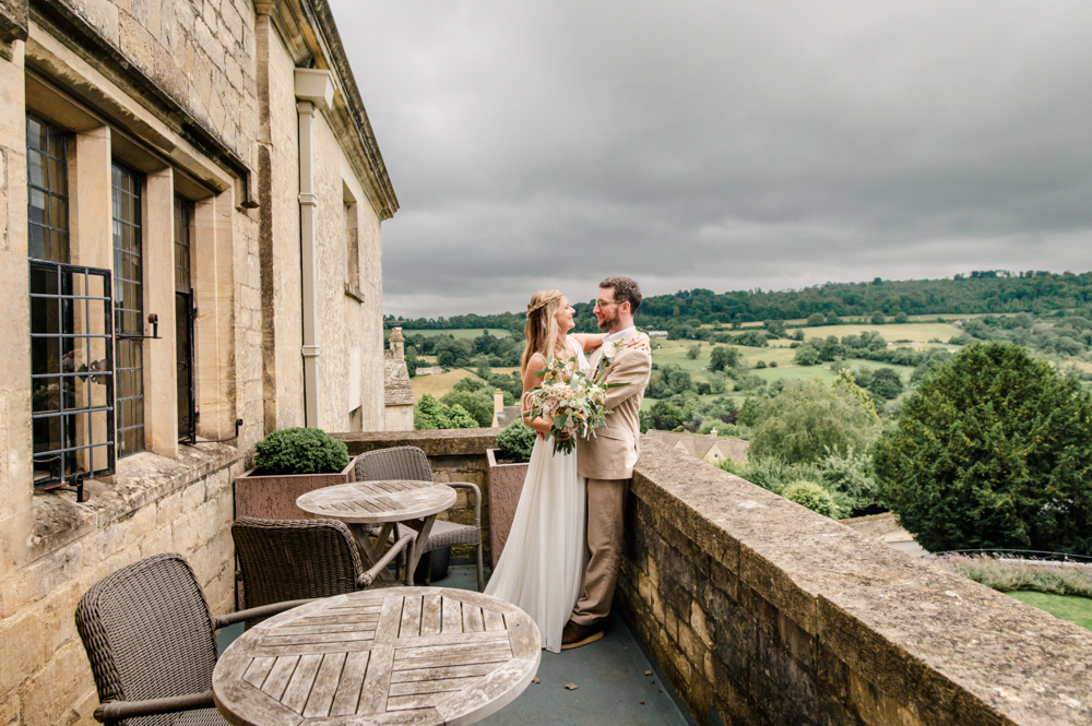 wedding couple on balcony with countrysde views