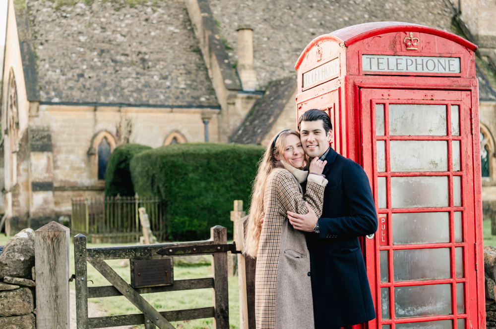 couple by red telephone box cotswolds