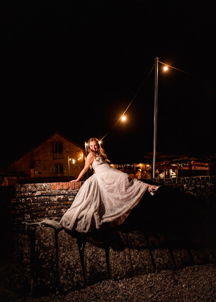 bride sitting on a wall