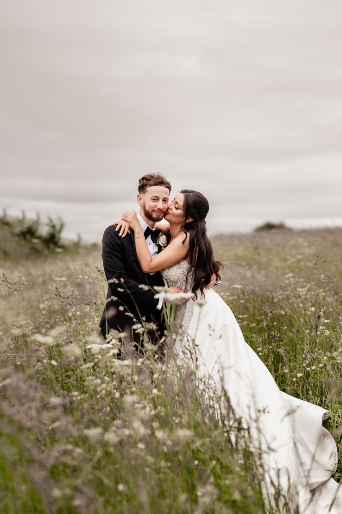 bride and groom in a meadow
