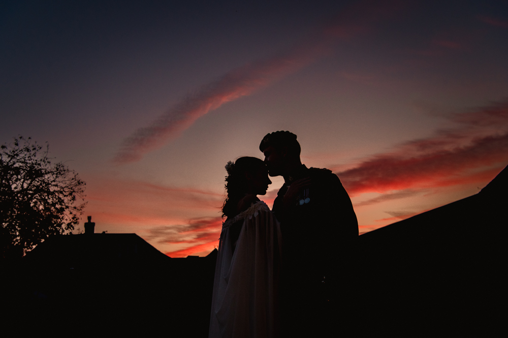 bride and groom silhouette red sky