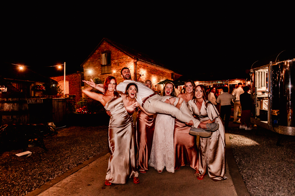 bridesmaids picking up groom
