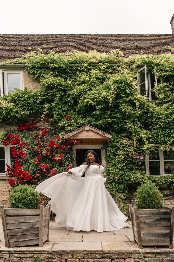bride twirling in front of  country cottage