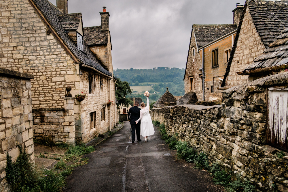 bride and groom  walking in a village