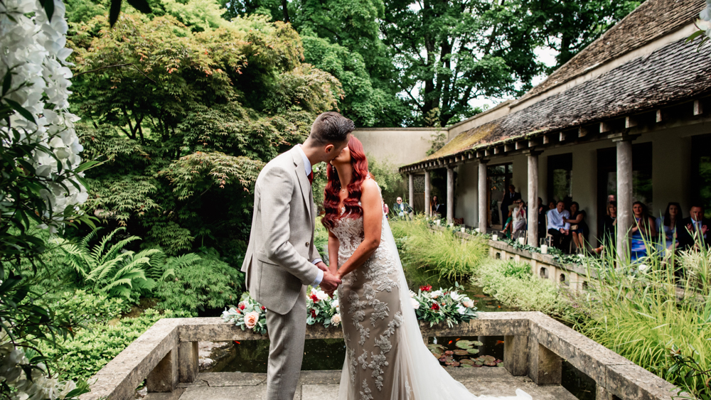 bride and groom kiss garden wedding