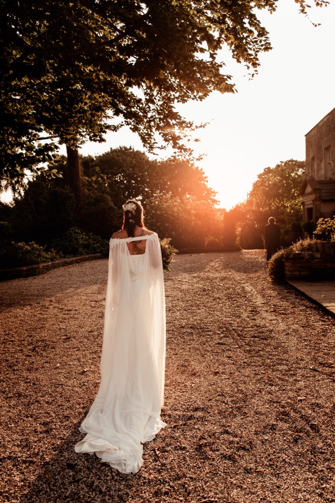 sunset wedding dreamy bride wearing a cape veil