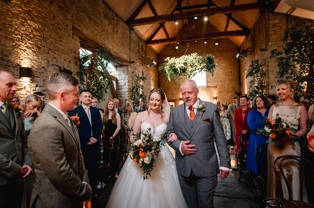 bride walking down the aisle barn wedding