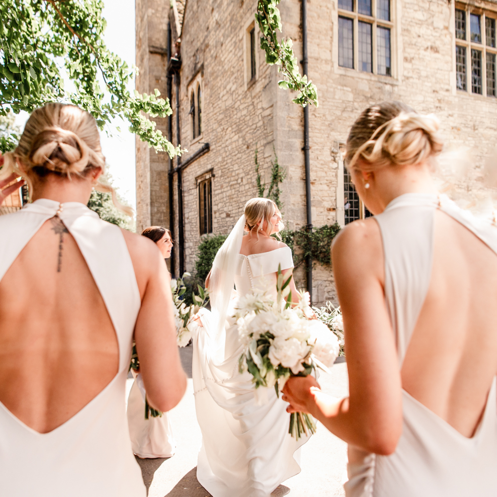 bride walking with bridesmaids stonehouse court hotel