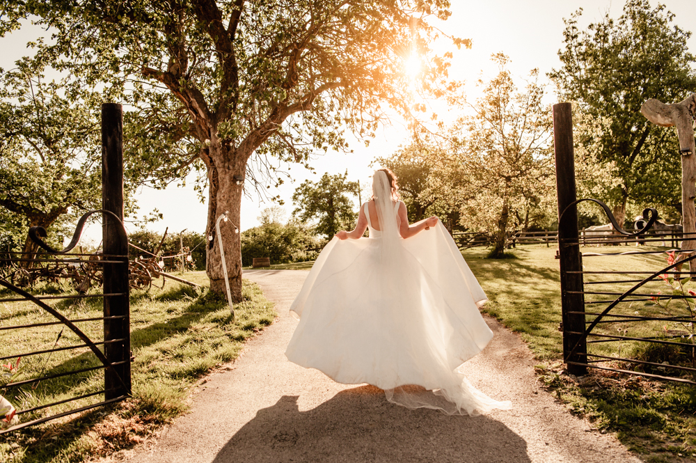 atristic shots of a bride walking in a dreamy ethereal scene at sunset
