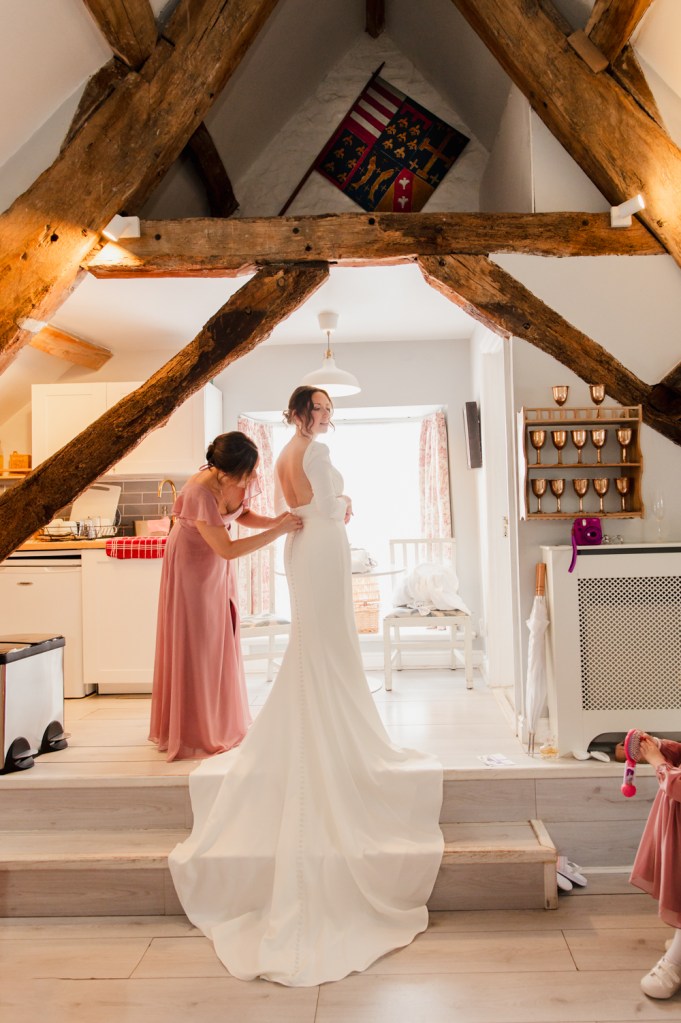 bride putting dress on