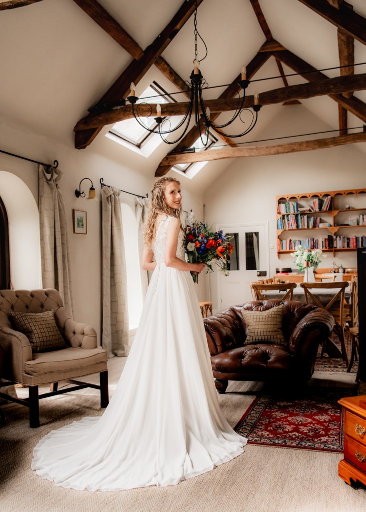 soft portrait of bride in a wedding dress with a train