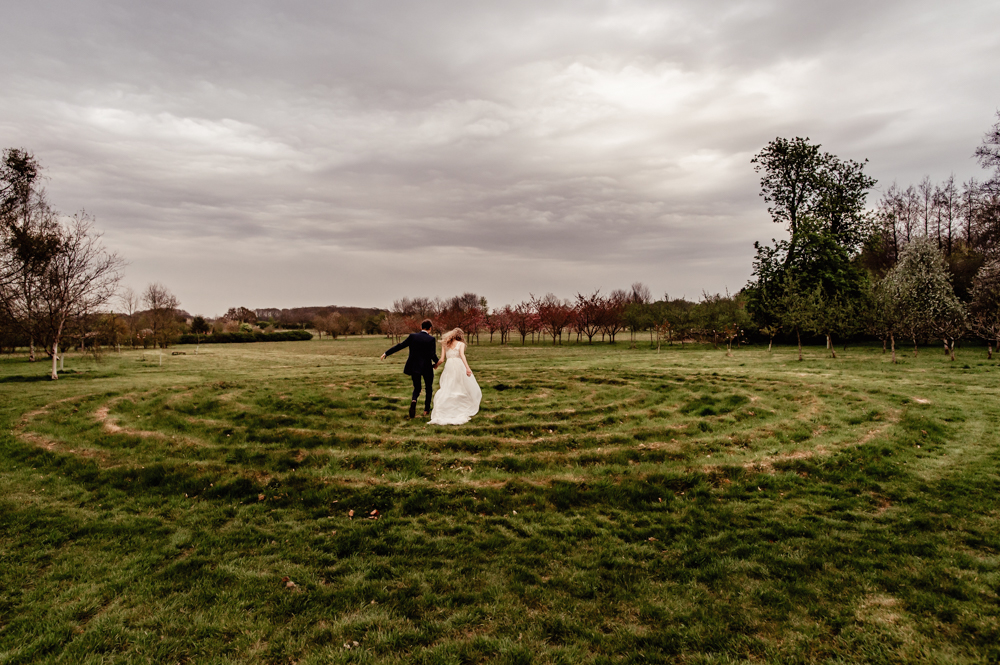 bride and groom running in a dreamy garden matara centre wedding