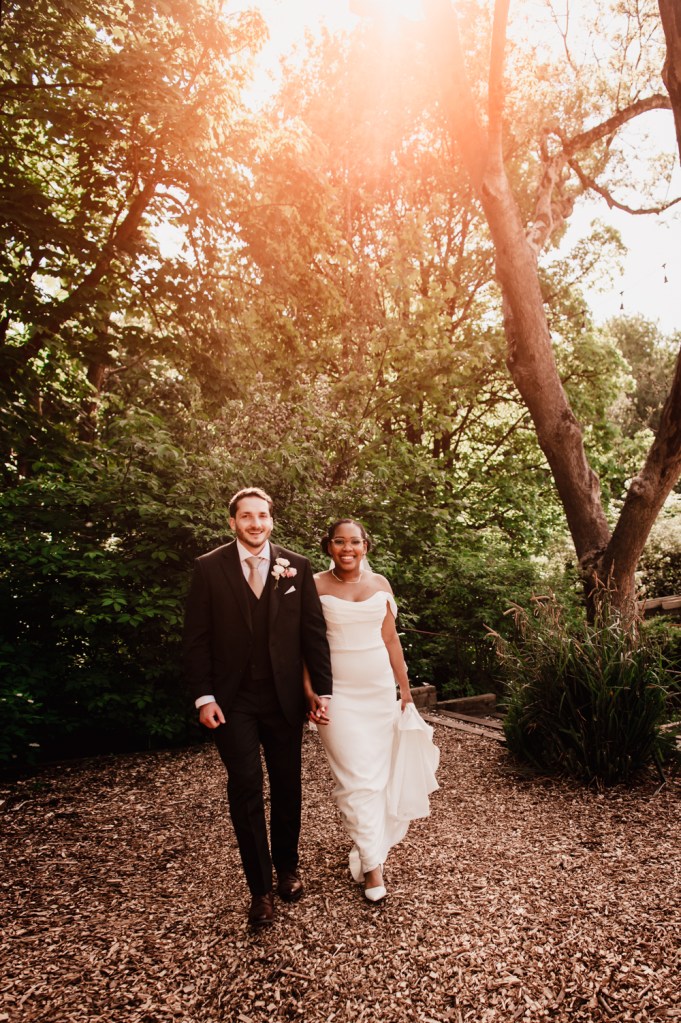 bride and groom walking in the woods at sunset wedding photography in the cotswolds