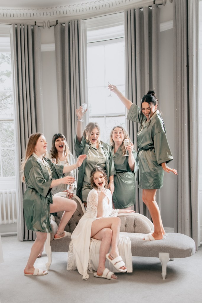 bride having fun with bridesmaids eastington park