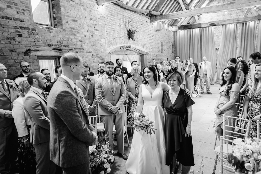 bride crying looking at groom emotional  wedding photography milton end barn