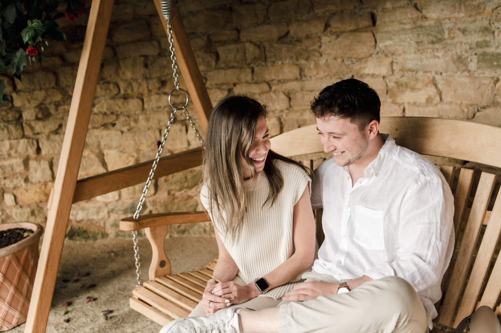 a candid moment of a couple chatting cotswold engagement