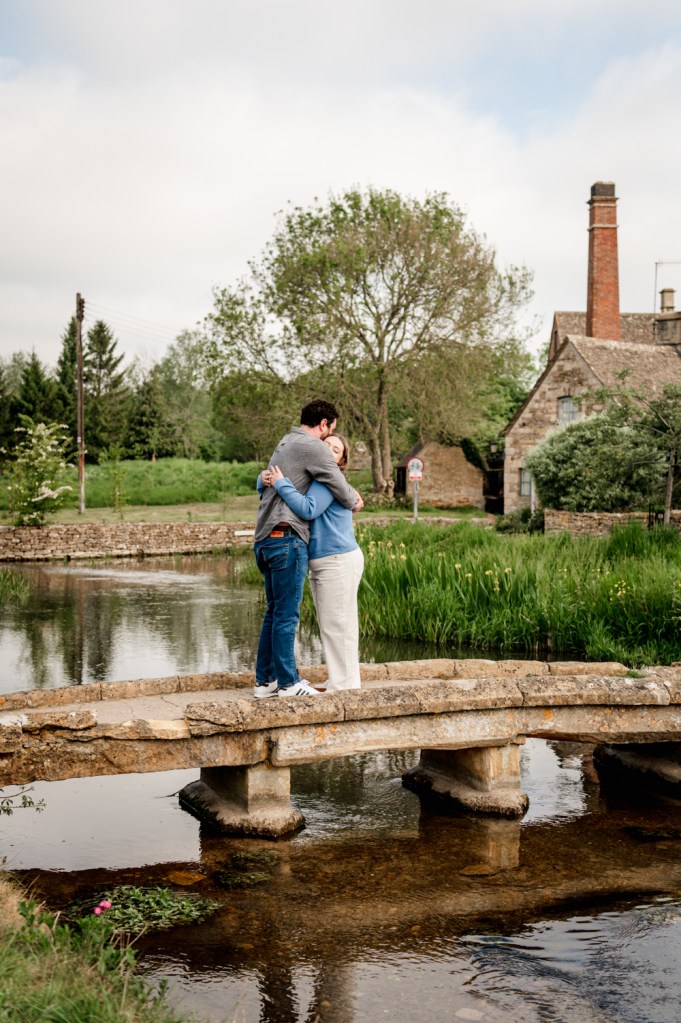 couple hugging cotswolds village