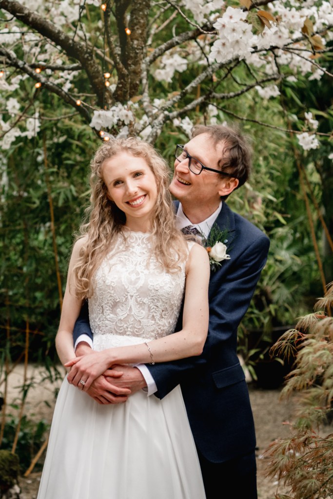 bride and groom in a colourful garden matara centre cotswolds