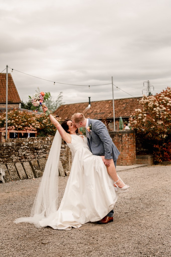 a light and soft photos of a groom kissing bride in an editorial style wedding photography 