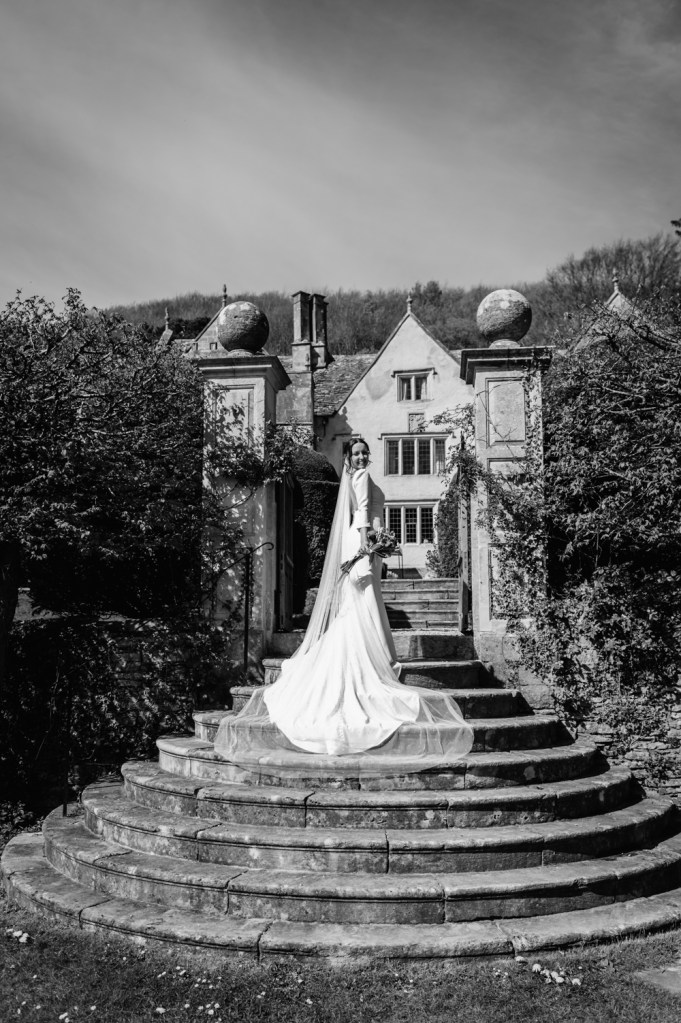 bride on steps owlpen manor cotswolds